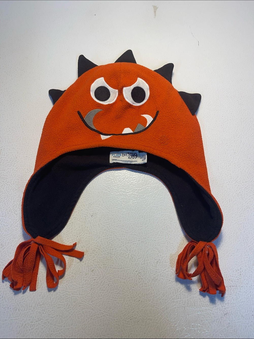 Place Orange Monster Fleece Hat with Black Lining and Embroidered Detail